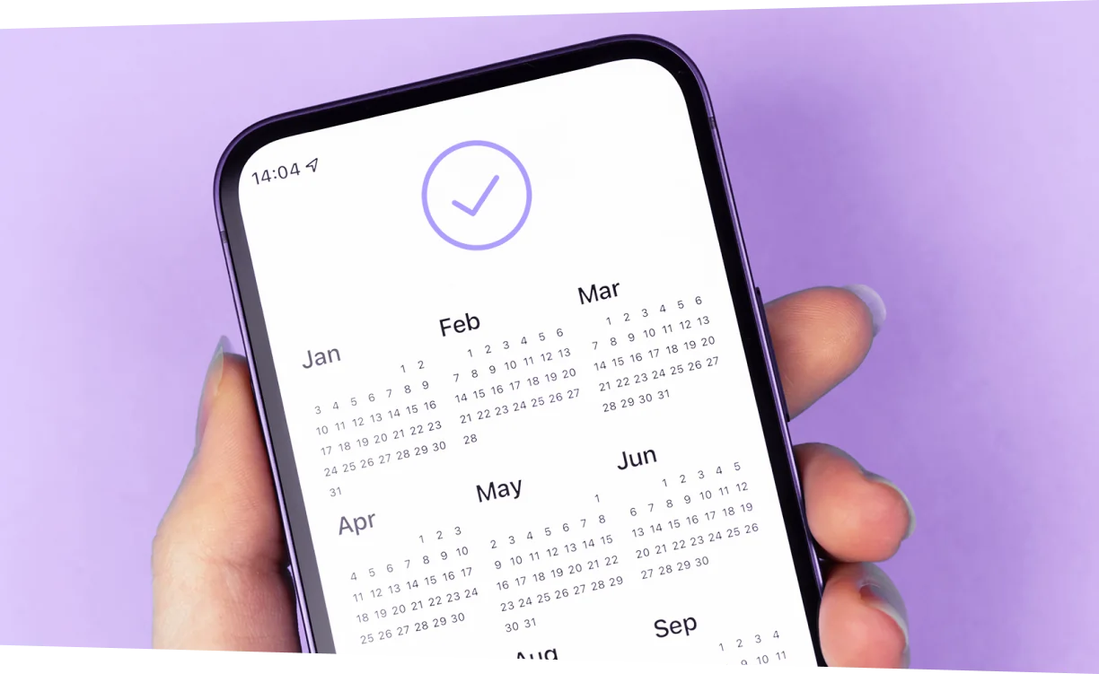 Celular com calendário e sinal positivo na tela.